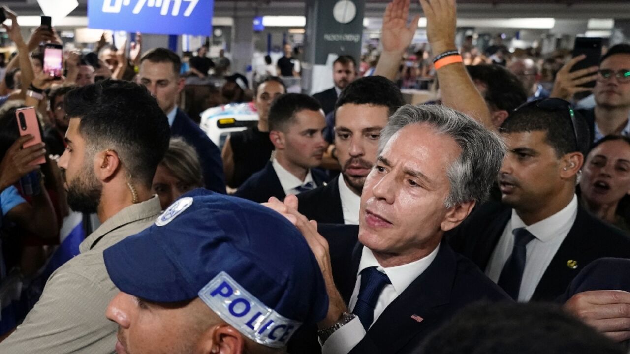 US Secretary of State Antony Blinken is applauded by people as he visits a donation center in Tel Aviv for victims of the weekend attack by Palestinian militants 