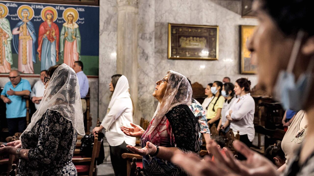 Palestinian Greek Orthodox Christians pray during Sunday Mass at the Church of Saint Porphyrius in Gaza City, on May 30, 2021.