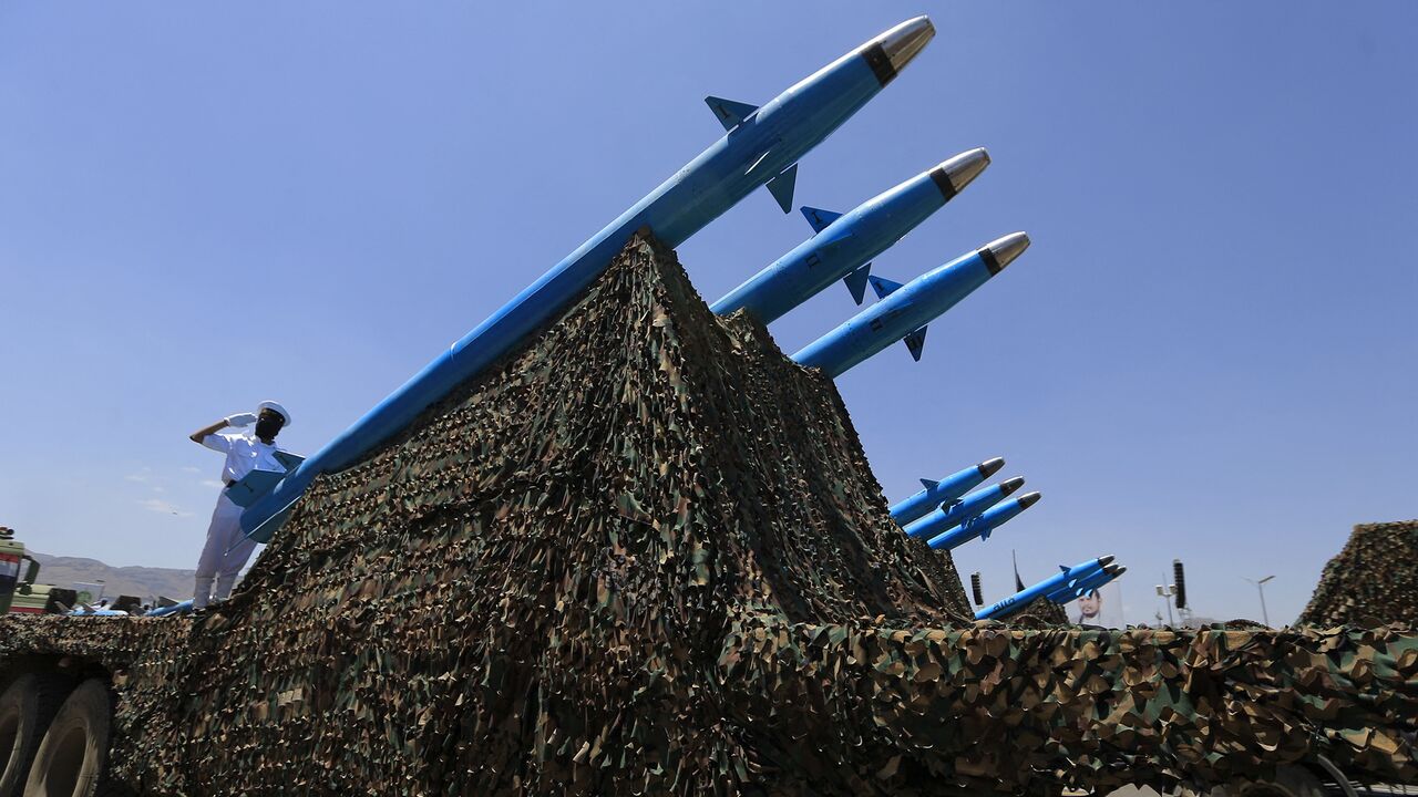 Houthi soldiers stand guard on a missile carrier during an official military parade to mark the ninth anniversary of the Houthis' takeover of Sanaa, the Yemeni capital, Sept. 21, 2023.