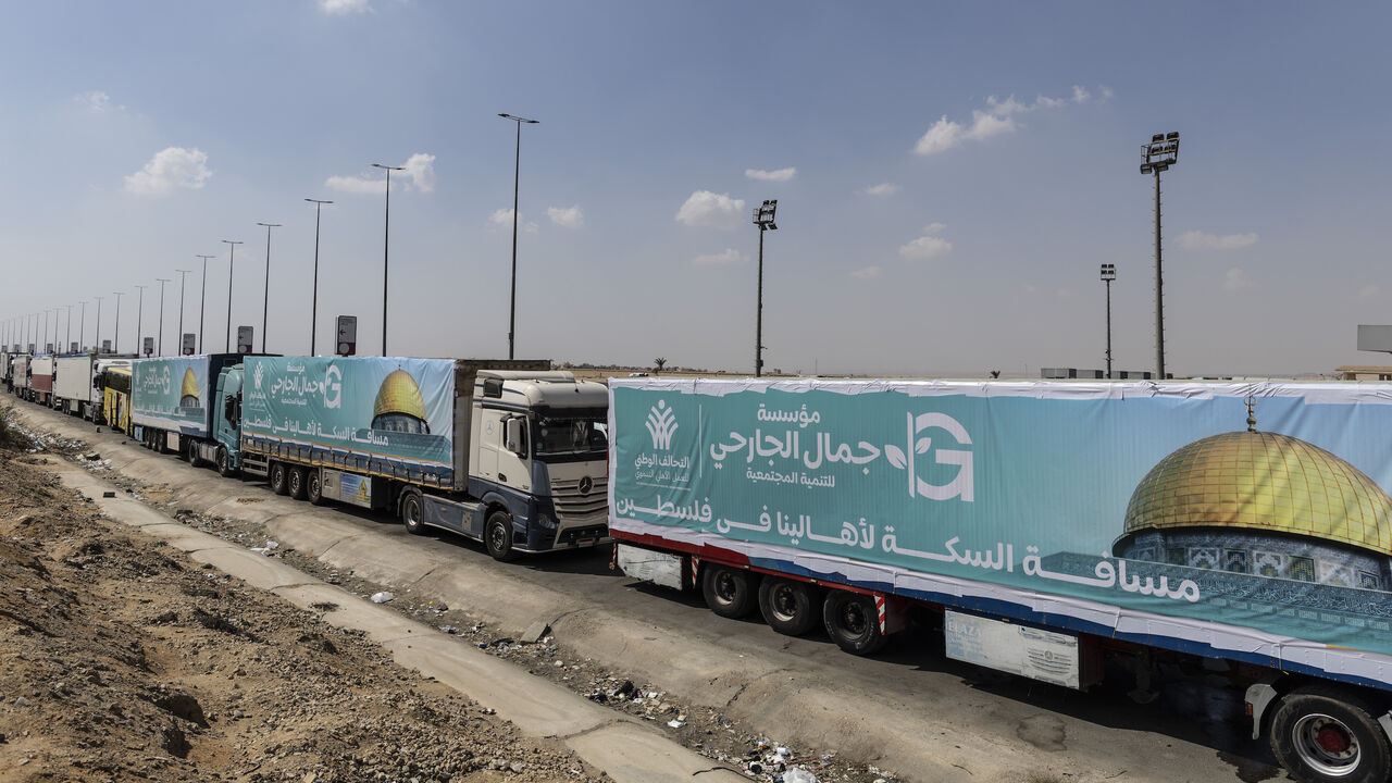 onvoy trucks loaded with supplies are seen at Cairo-Ismailia Desert Road on Oct. 14, 2023, in Cairo.