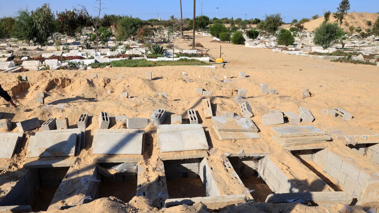 Graves are made ready to receive the new dead in the cemetery in Rafah, south of the Gaza Strip.