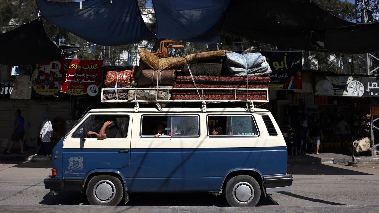 A Palestinian van carrying a family and their belongings arrives at the Rafah refugee camp, in the southern Gaza Strip on Oct. 15, 2023.