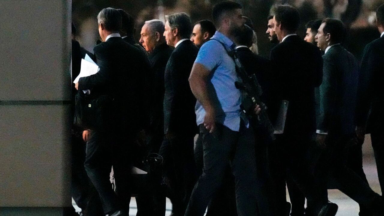 US Secretary of State Antony Blinken walks into a building with Israel's Prime Minister Benjamin Netanyahu.