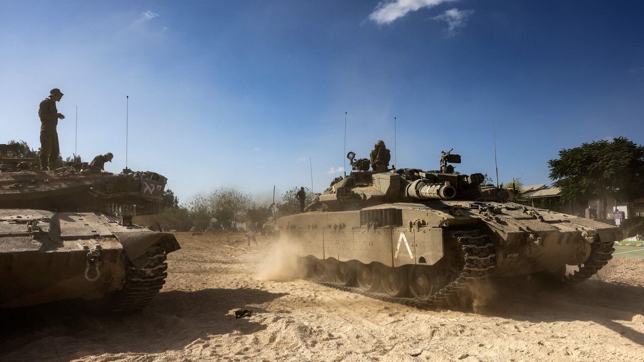 Merkava tanks roll into position outside Kibbutz Beeri near the border with the Gaza Strip on October 20, 2023, amid the ongoing battles between Israel and the Palestinian group Hamas. Thousands of people, both Israeli and Palestinians have died since October 7, 2023, after Palestinian Hamas militants based in the Gaza Strip, entered southern Israel in a surprise attack leading Israel to declare war on Hamas in Gaza on October 8. (Photo by RONALDO SCHEMIDT / AFP) (Photo by RONALDO SCHEMIDT/AFP via Getty Ima