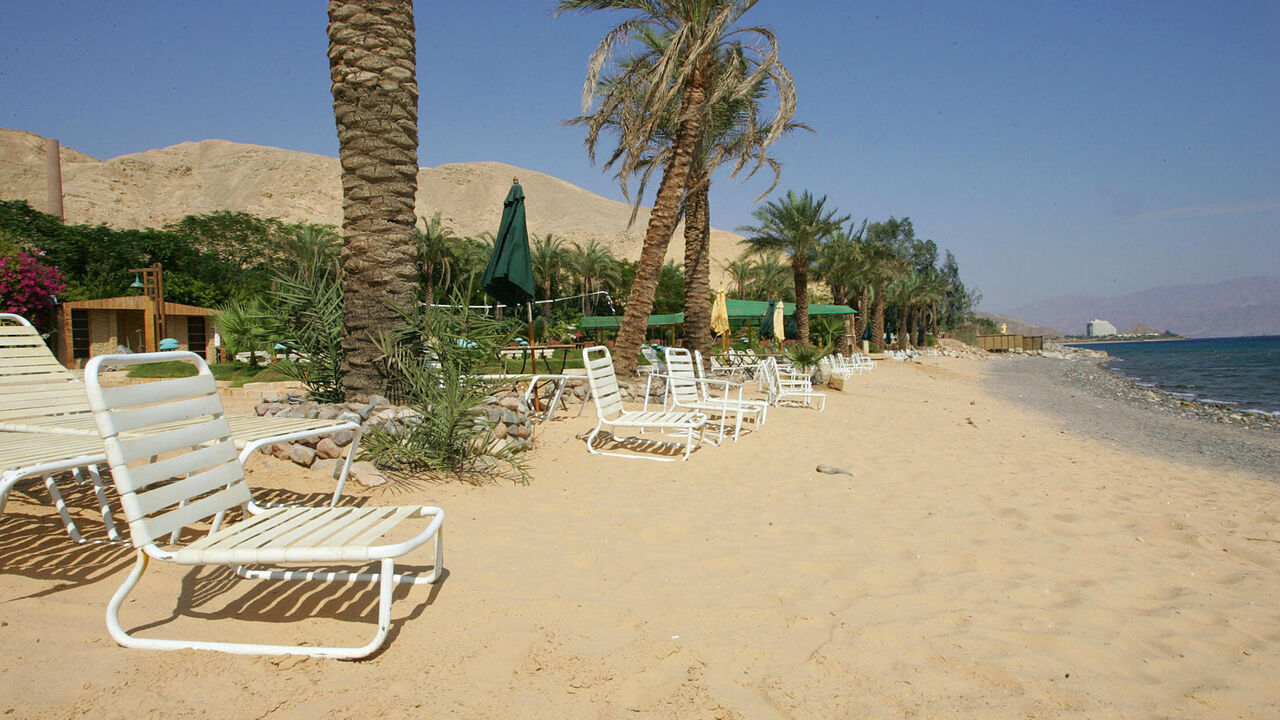 TABA, EGYPT: Beach resorts close to the Egyptian Taba Hilton (background-R) remain empty 11 October 2004, four days after three attacks targeted this well-known hotel in the Sinai peninsula next to the Israeli border and another two minor resorts, killing at least 32 people and causing the exodus of thousands of Israeli tourists from the area called the Egyptian Riviera. Israel's resort of Eilat, close to the border with Egypt, is set for a boom as thousands of Israelis who regularly holiday in Sinai look e