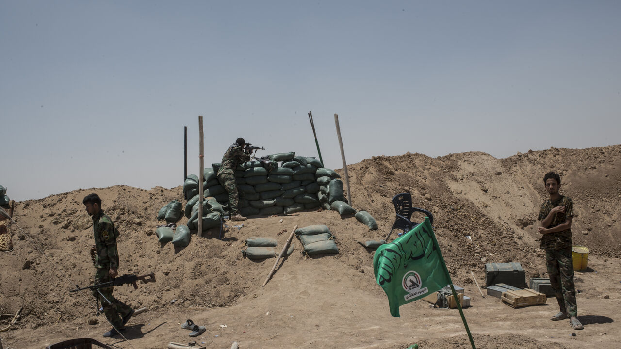 NINEVEH, IRAQ - JUNE 20: Iraqi PMF fighters June 20, 2017 on the Iraq-Syria border in Nineveh, Iraq. The Popular Mobilisation Front (PMF) forces, composed of majority Shi'ite militia, part of the Iraqi forces, have pushed Islamic State militants from the north-western Iraq border strip back into Syria. The PMF now hold the border, crucial to the fall of Islamic State in Mosul, blocking the Islamic State supply route for militants from Syria to Mosul. (Martyn Aim/Getty Images).