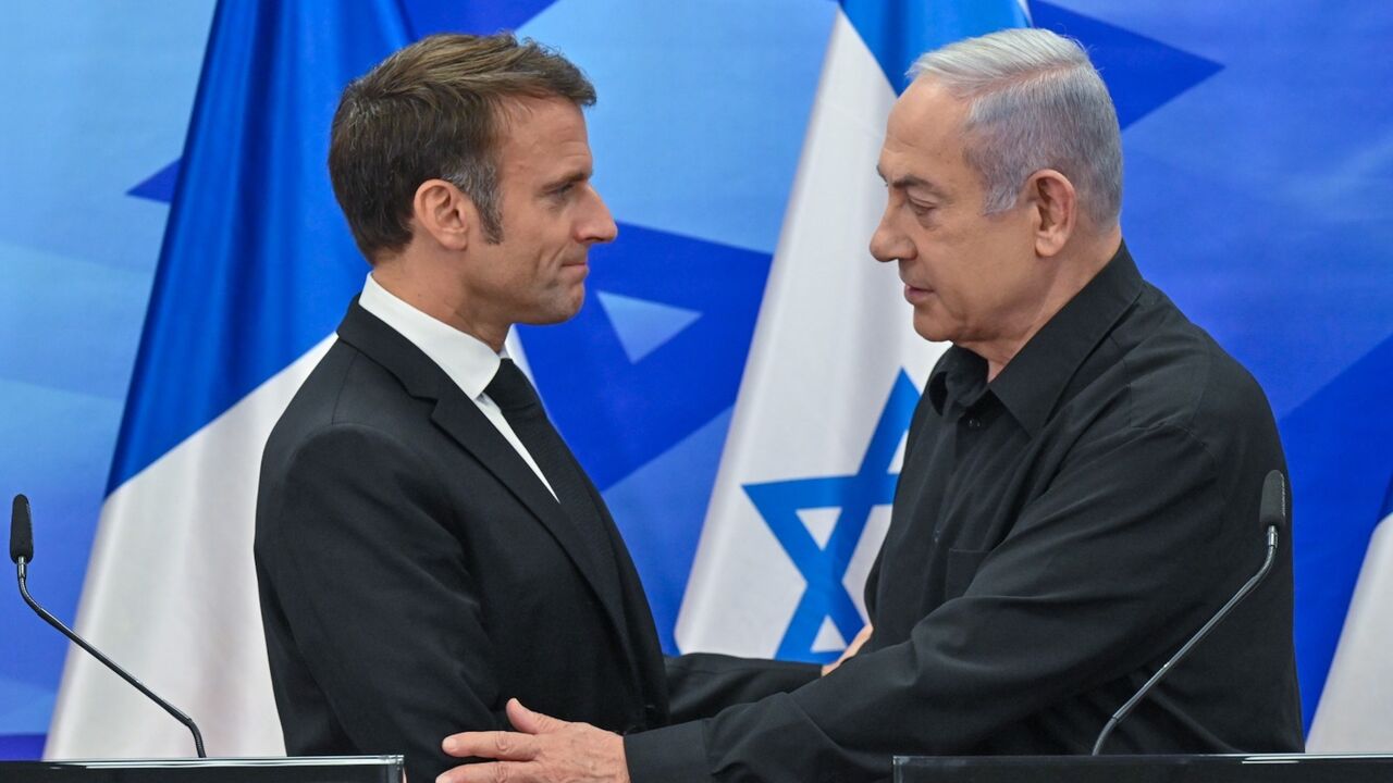 Macron shakes hands with Netanyahu