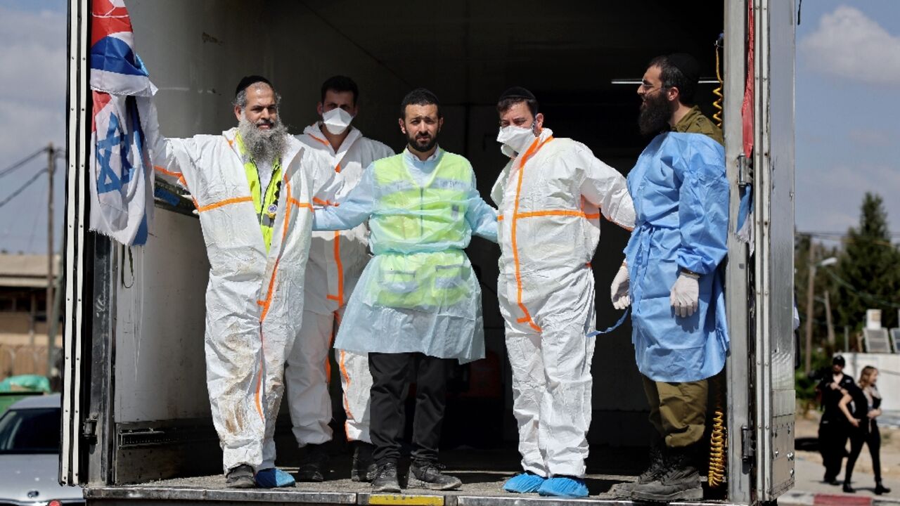 Hundreds of bodies waiting to be identified or to be taken for burial are stored in containers