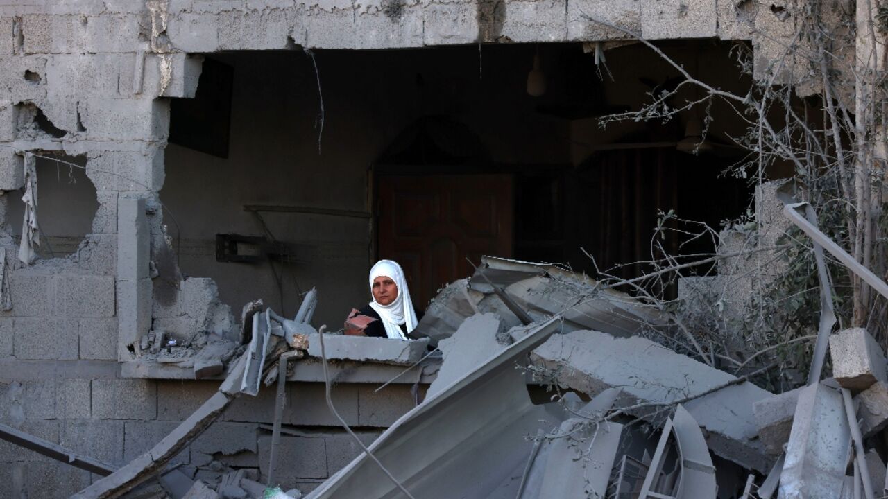 A woman looks out onto the rubble of a building destroyed in an Israeli bombardment in Rafah in the southern Gaza Strip on October 21, 2023 A woman looks out onto the rubble of a building destroyed in an Israeli bombardment in Rafah in the southern Gaza Strip on October 21, 2023