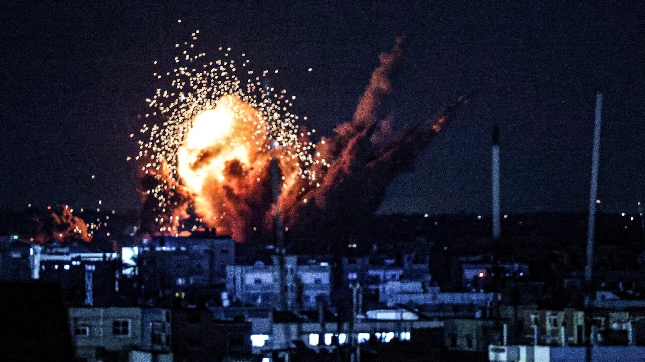 A ball of fire and smoke rise above buildings during an Israeli strike on Rafah in the southern Gaza Strip, on October 15, 2023