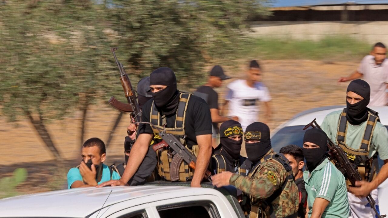 Palestinian militants move towards the border fence with Israel from Khan Yunis in the southern Gaza Strip