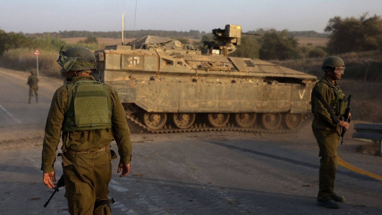 Israeli soldiers and an armoured personnel carrier near Sderot on the border with the Gaza Strip Israeli soldiers and an armoured personnel carrier near Sderot on the border with the Gaza Strip