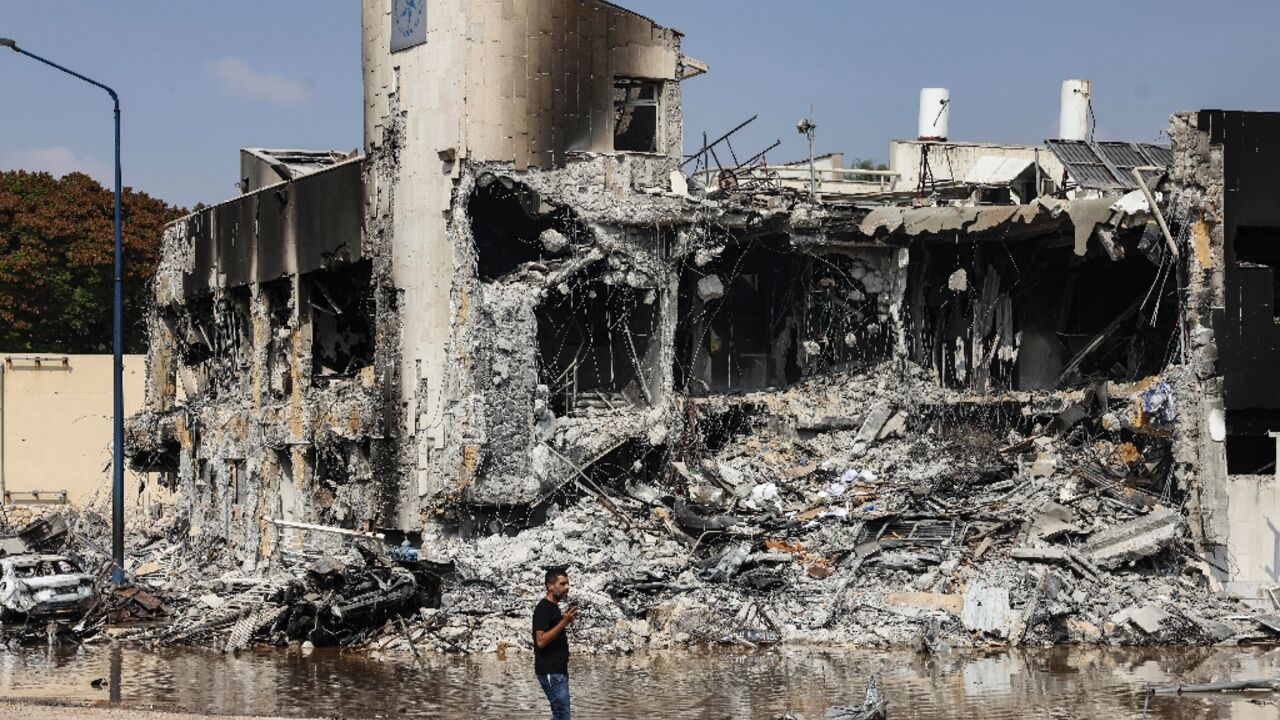 A man walks past an Israeli police station in Sderot after it was damaged during battles to dislodge Hamas militants 