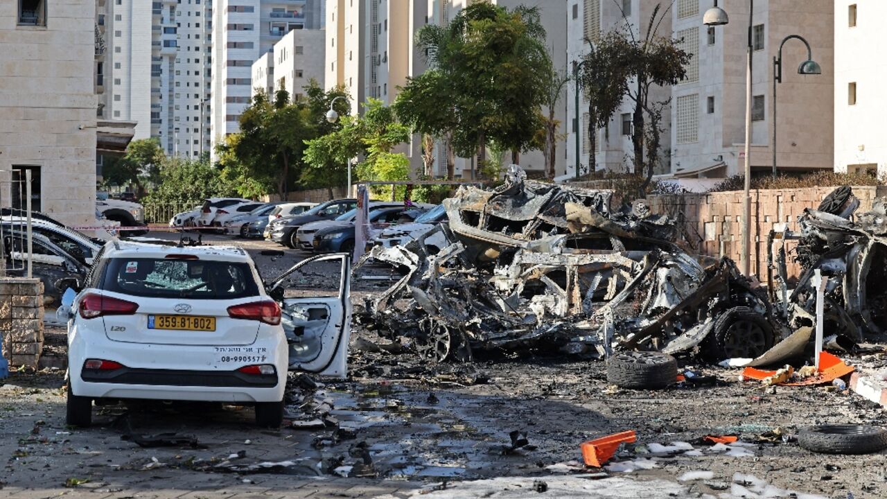 Burnt out vehicles in Ashkelon are pictured following a rocket attack from the Gaza Strip Burnt out vehicles in Ashkelon are pictured following a rocket attack from the Gaza Strip