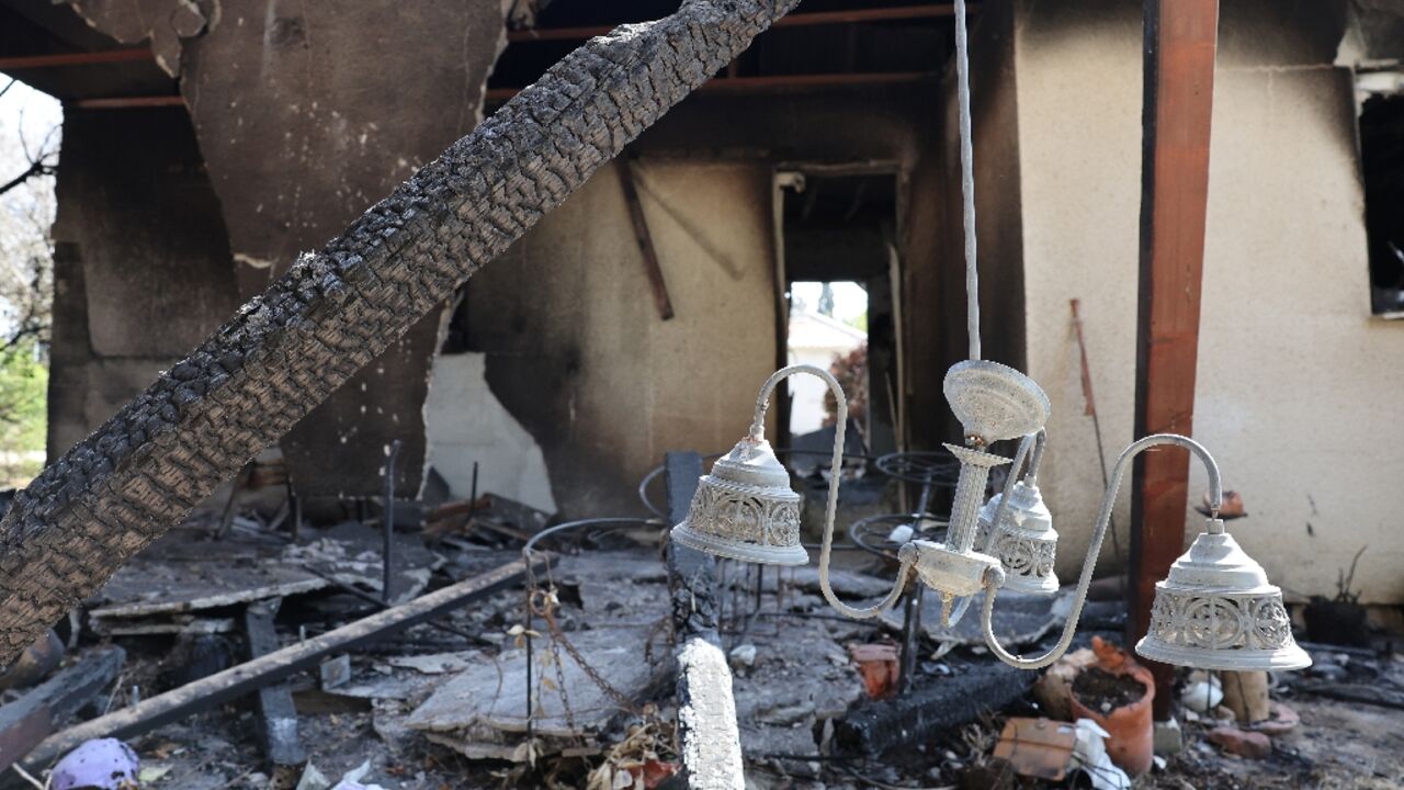 Charred debris and personal belongings are scattered at Israel's kibbutz Nir Oz following the October 7 attack by Hamas militants