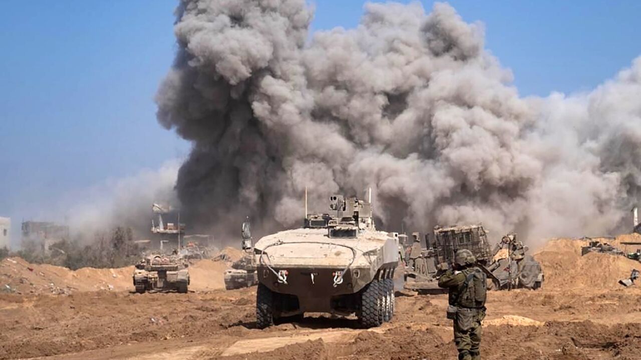 A picture released by the Israeli army on November 5, 2023 shows Israel military vehicles and heavy smoke inside the Gaza Strip as battles between Israel and the Palestinian Hamas movement continue