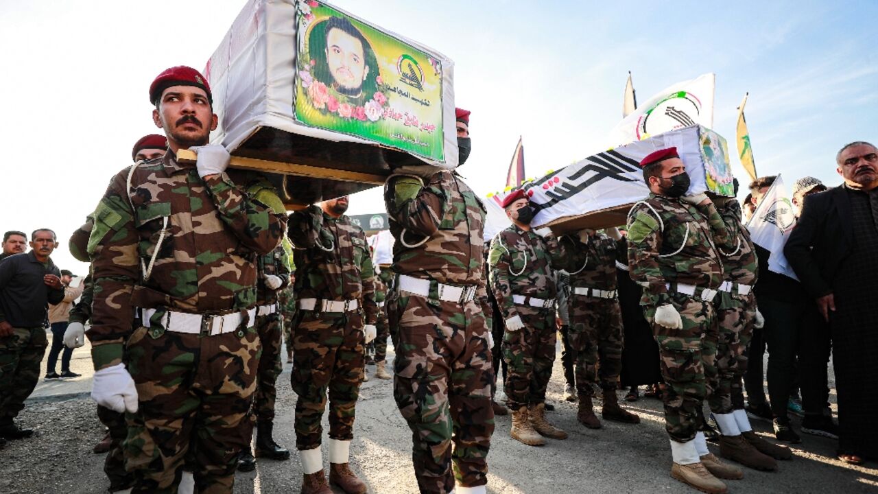 Hashed al-Shaabi soldiers carry the coffins of fighters killed in the US strikes Hashed al-Shaabi soldiers carry the coffins of fighters killed in the US strikes