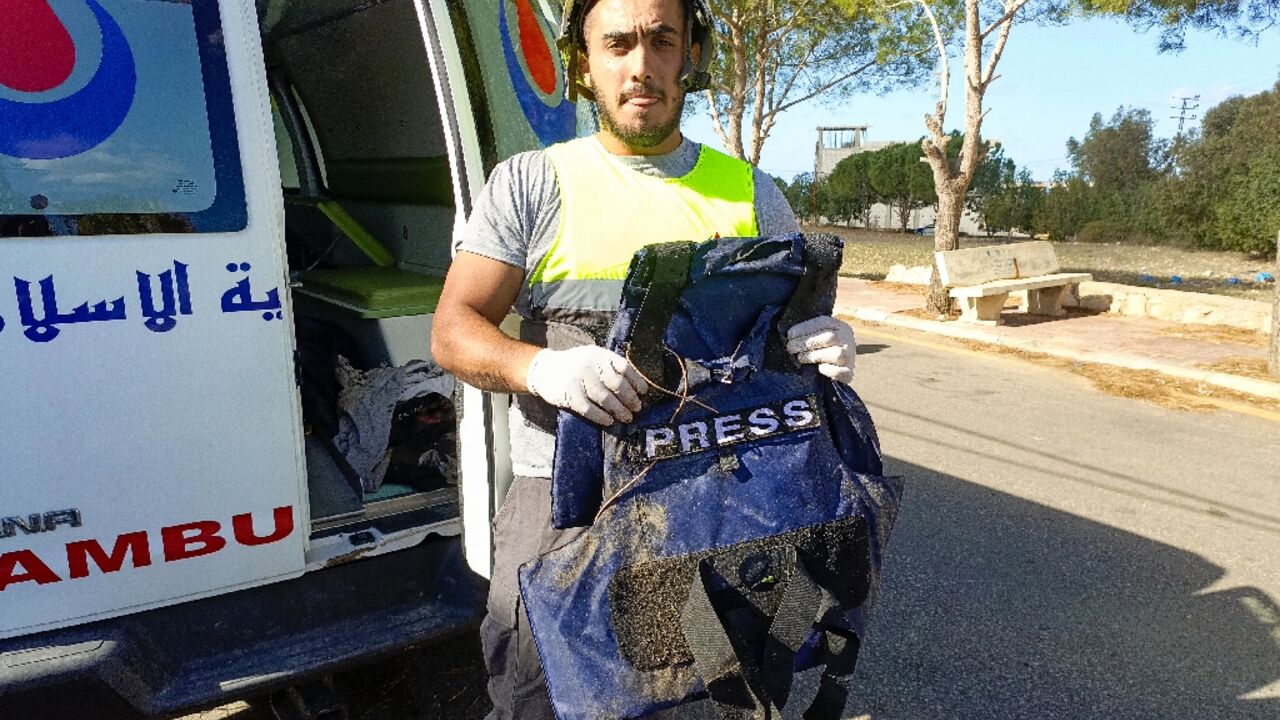 A Lebanese rescuer holds the bullet proof vest of one of two journalists working for Al-Mayadeen television killed in Israeli bombardment of southern Lebanon A Lebanese rescuer holds the bullet proof vest of one of two journalists working for Al-Mayadeen television killed in Israeli bombardment of southern Lebanon