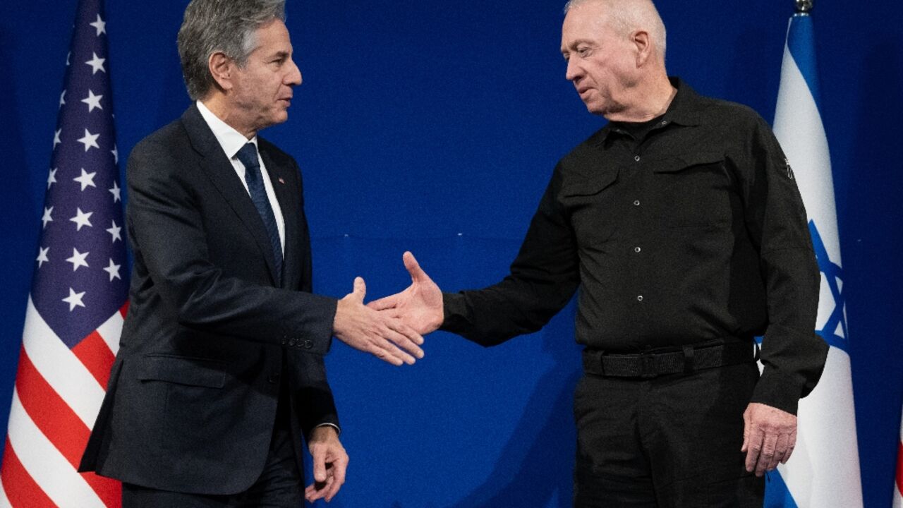 Israeli Defence Minister Yoav Gallant (R) and US Secretary of State Antony Blinken shake hands prior to a meeting in Tel Aviv