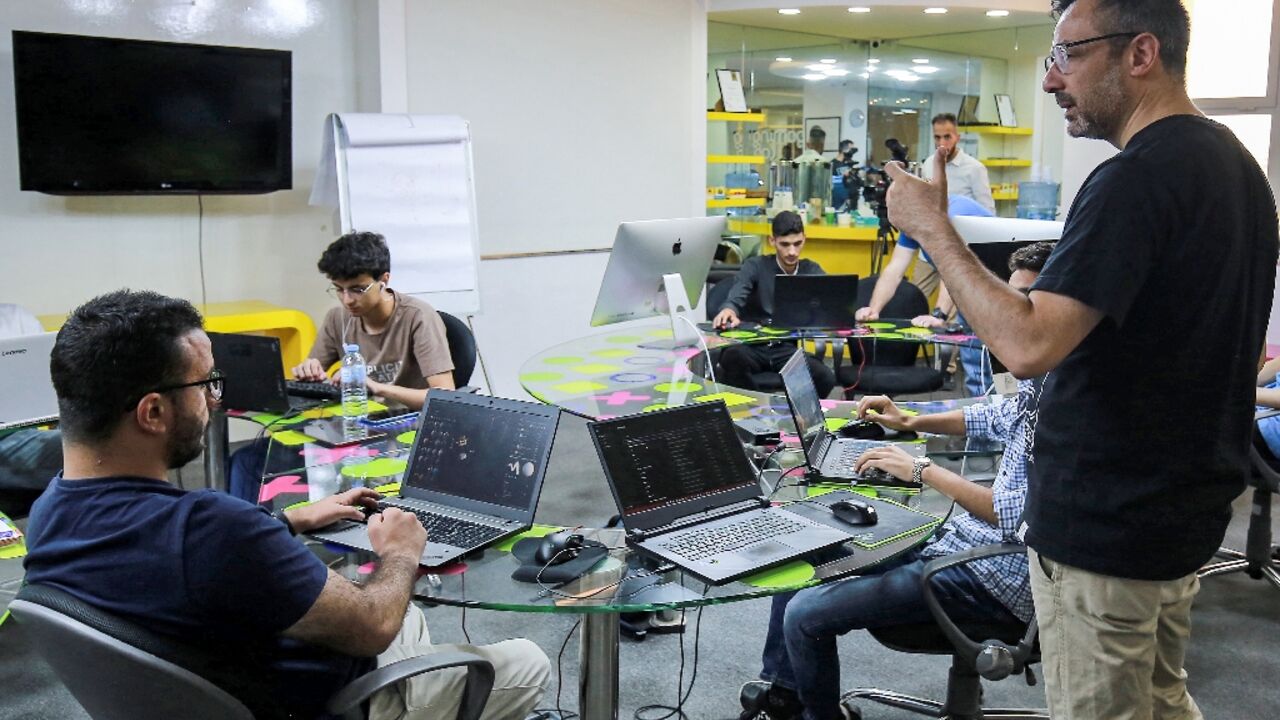 Nour Khrais, technical partner in The Jordan Gaming Lab, which provides equipment and educational courses to young people on all aspects of the gaming industry, talks to his team at their office in Amman