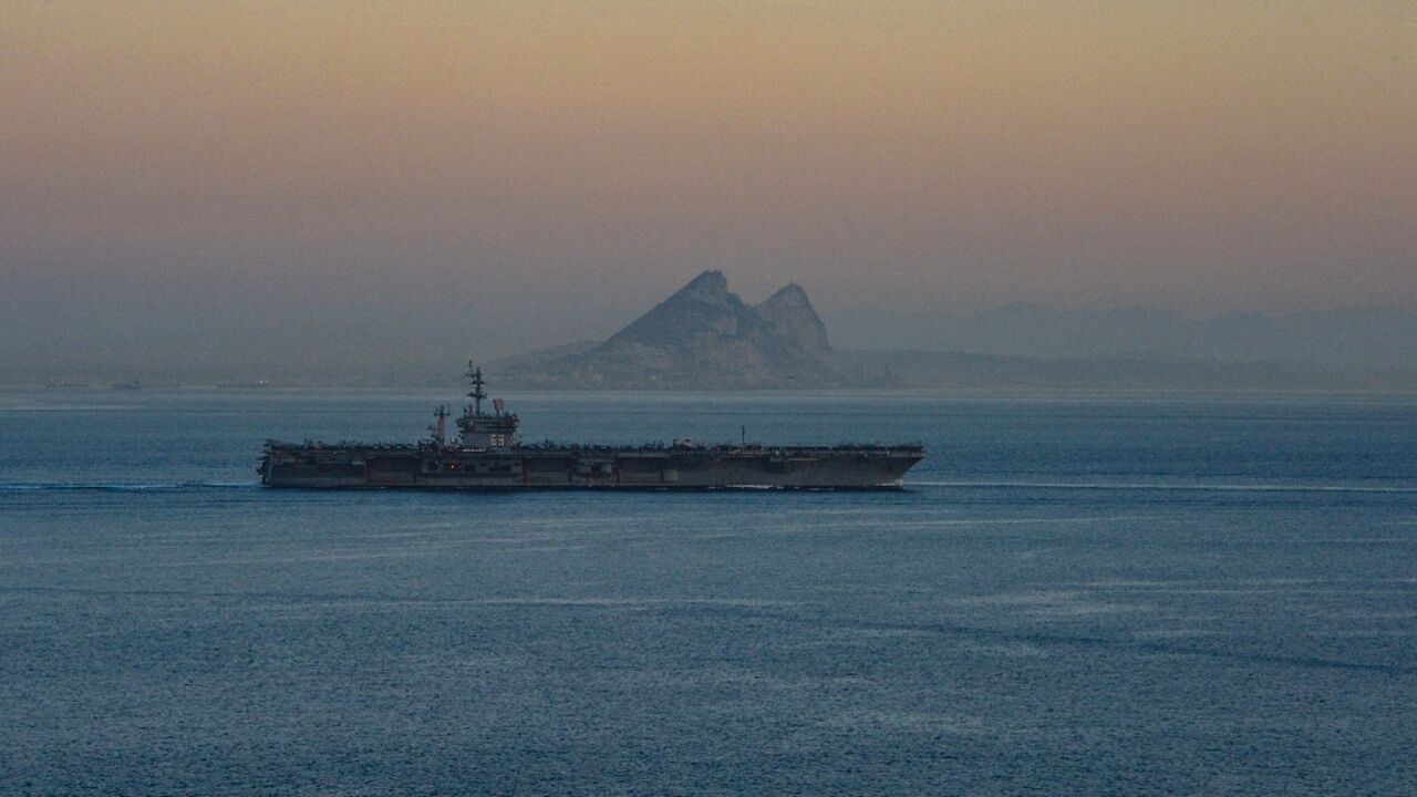 A photo obtained from the US Department of Defense shows the USS Dwight D. Eisenhower aircraft carrier transiting the Strait of Gibraltar on October 28, 2023 A photo obtained from the US Department of Defense shows the USS Dwight D. Eisenhower aircraft carrier transiting the Strait of Gibraltar on October 28, 2023