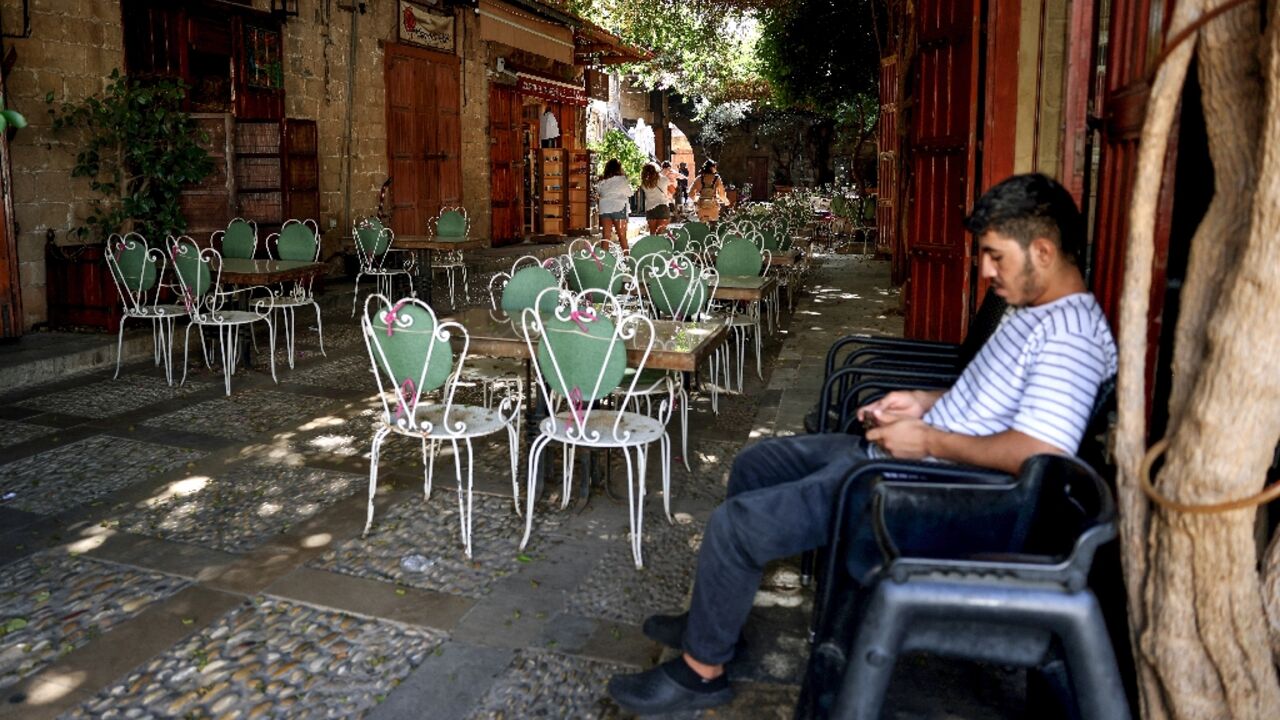 Waiting for customers at an empty restaurant in Lebanon's historic city of Byblos Waiting for customers at an empty restaurant in Lebanon's historic city of Byblos
