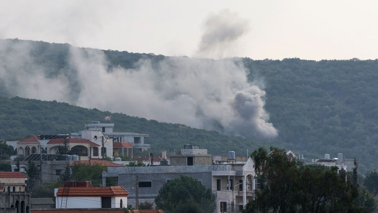 Smoke billows following Israeli artillery bombing on the outskirts of the Lebanese border village of Aita al-Shaab, from an Israeli military position overlooking the area, Oct. 9, 2023.