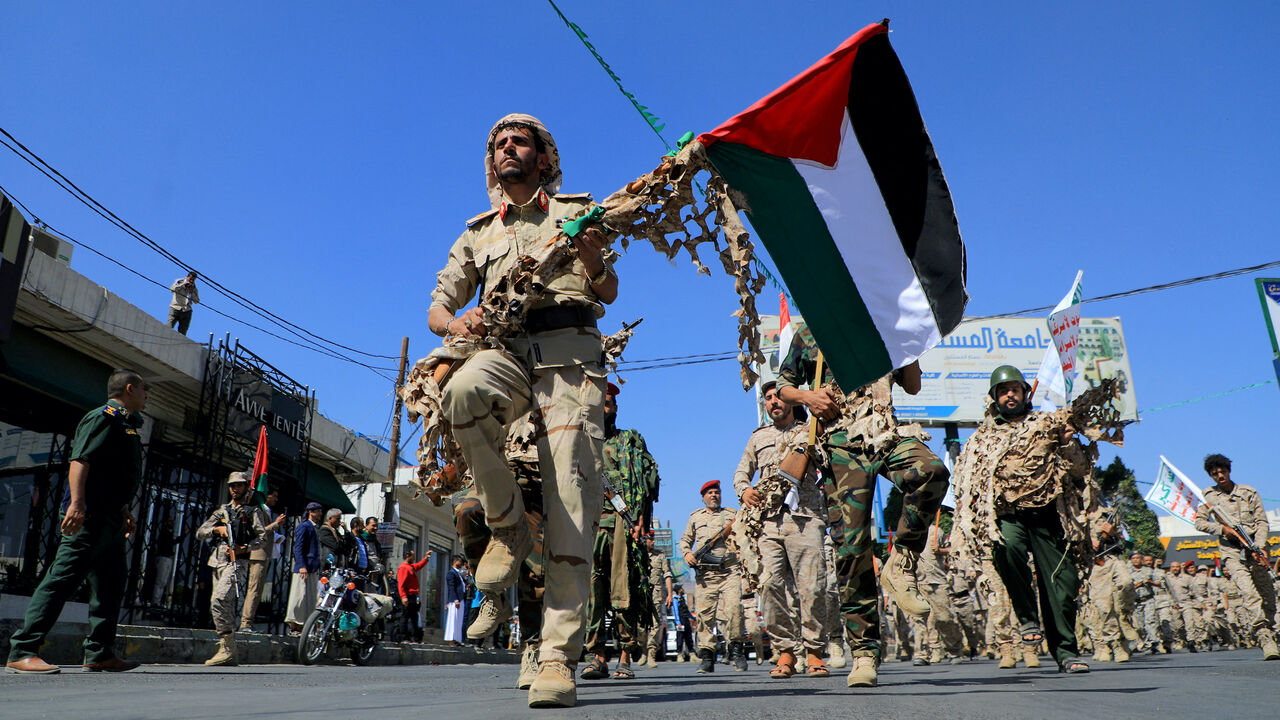 Forces loyal to Yemen's Huthi rebels hold up Palestinian flags as they march in a show of solidarity with the Palestinians on October 15, 2023, in Sanaa. (Photo by MOHAMMED HUWAIS/AFP via Getty Images)