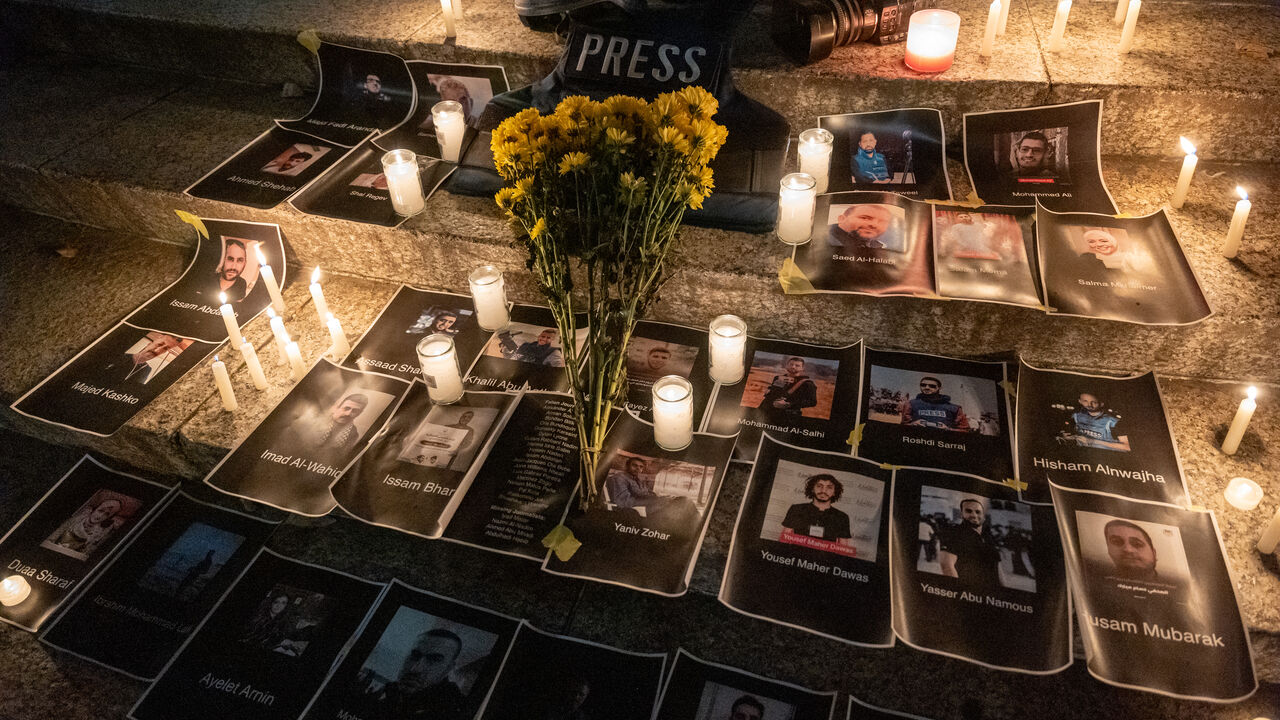 NEW YORK, NY - NOVEMBER 06: Flowers and candles are placed among pictures of journalists at a vigil in lower Manhattan on November 6, 2023 in New York City. The vigil is held to remember and celebrate the lives of journalists killed in recent fighting in Israel, Gaza and Lebanon. Since Hamas launched its attack against Israel on October 7 and Israel began a prolonged attack on the militant Palestinian group, at least 37 journalists and media workers are counted among an estimated 11,000 killed. (Photo by Sp