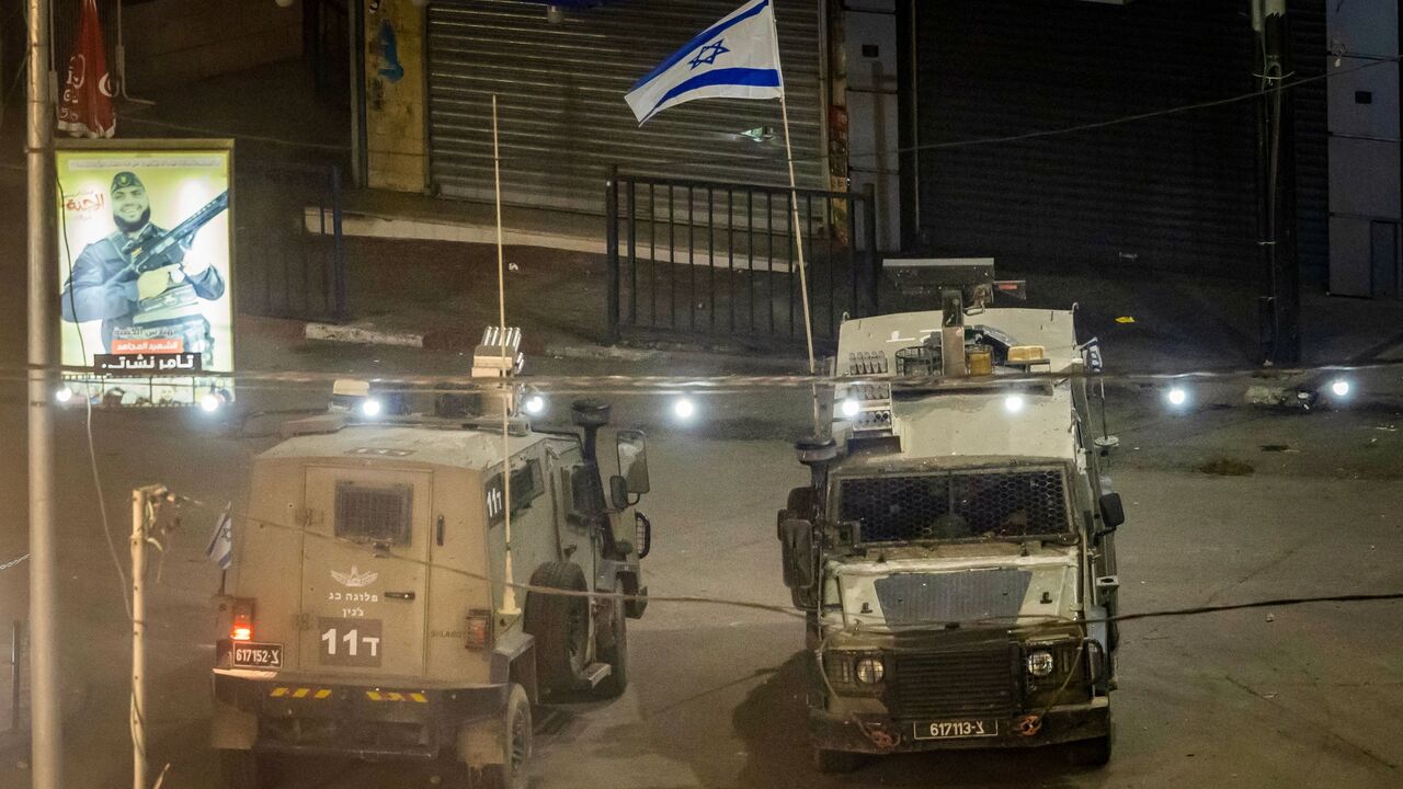 Israeli armored vehicles are pictured during a raid by the Israeli army in the Jenin refugee camp, the occupied West Bank, Nov. 16, 2023.