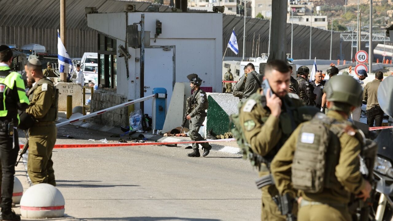 Israeli officers secure the scene after an attack by gunmen on a checkpoint guarding the access to road tunnels linking the occupied West Bank and Jerusalem Israeli officers secure the scene after an attack by gunmen on a checkpoint guarding the access to road tunnels linking the occupied West Bank and Jerusalem