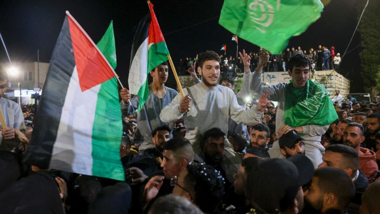 Crowds across the West Bank cheered and waved flags Crowds across the West Bank cheered and waved flags