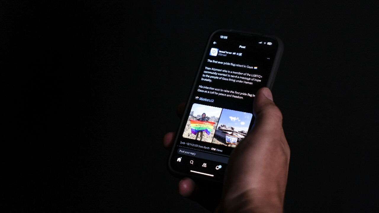 Amid the war ruins of Gaza, an Israeli soldier unfurls a rainbow flag in support of the LGBTQ community, in an image posted on social media