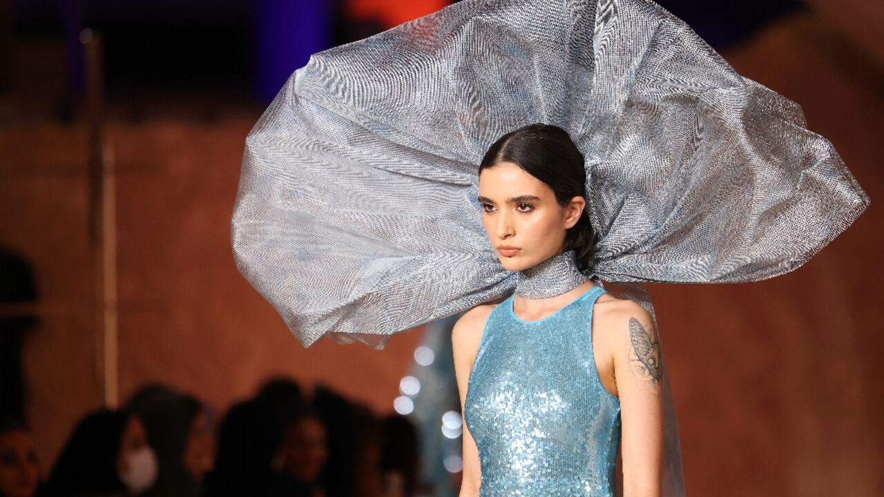 A model walks the catwalk at this year's Riyadh Fashion Week, a milestone in a country that used to require women to wear hijab headscarves and abaya robes in public