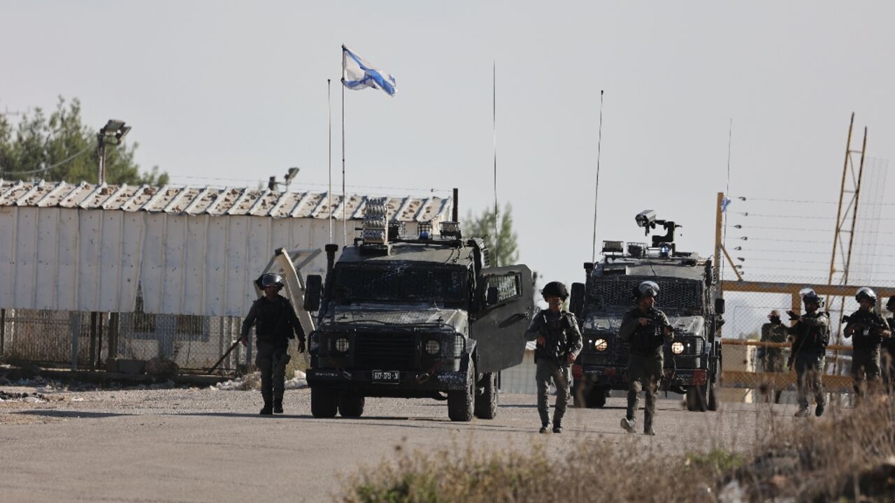 Israeli border police stand guard outside Ofer military camp in the occupied West Bank in preparation for the release of Palestinian prisoners in exchange for Israeli hostages held in Gaza Israeli border police stand guard outside Ofer military camp in the occupied West Bank in preparation for the release of Palestinian prisoners in exchange for Israeli hostages held in Gaza