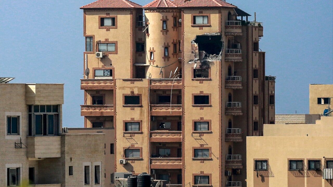 A gaping hole is seen in the side of the building that houses the bureau of Agence France-Presse in Gaza City A gaping hole is seen in the side of the building that houses the bureau of Agence France-Presse in Gaza City