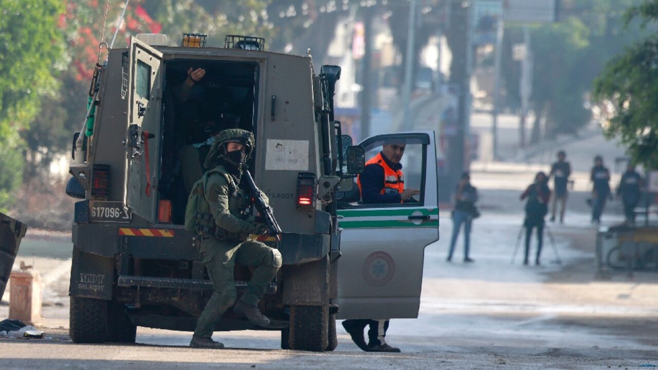 Israeli military vehicles arrive at the entrance to the Jenin refugee camp