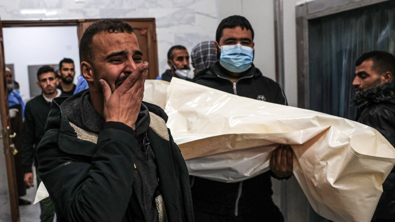 Mourners move the body of Palestinian, killed during an Israeli strike, from the EU hospital in Khan Yunis, southern Gaza Mourners move the body of Palestinian, killed during an Israeli strike, from the EU hospital in Khan Yunis, southern Gaza