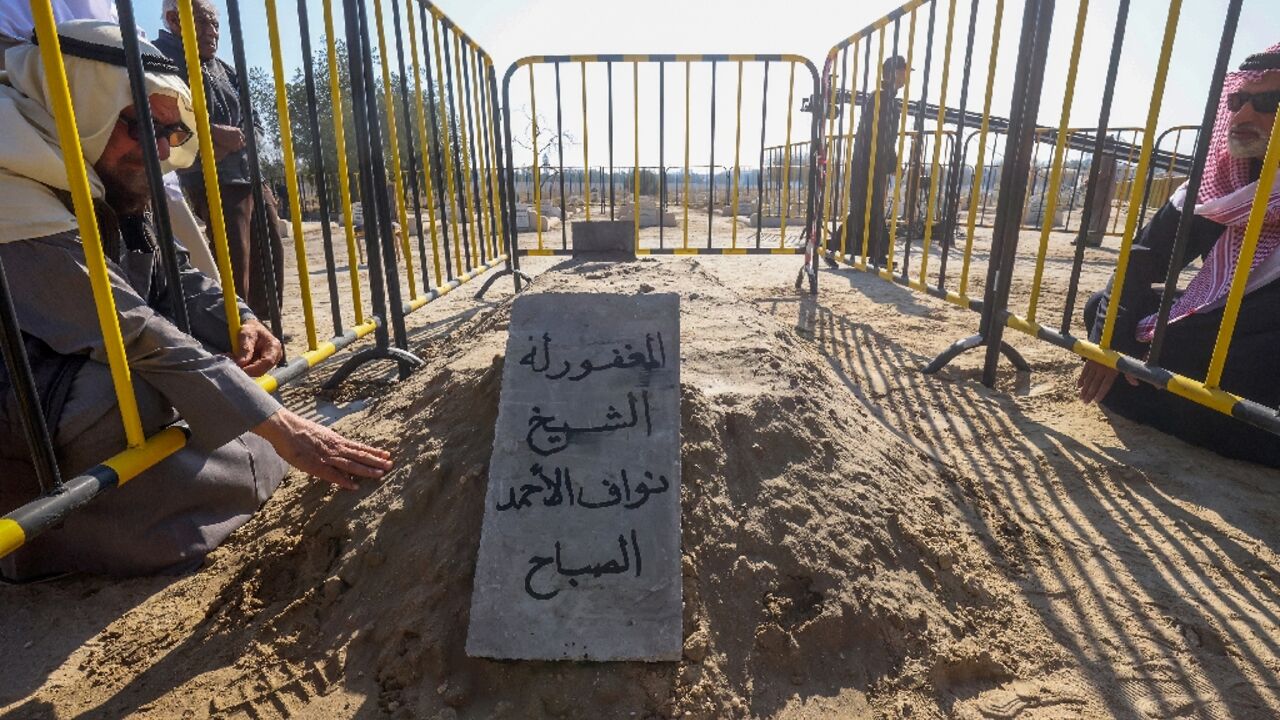 Mourners pray by the tomb of Kuwait's late Emir Sheikh Nawaf al-Ahmad Al-Sabah at Sulaibikhat cemetery in Kuwait City, after his low-key funeral