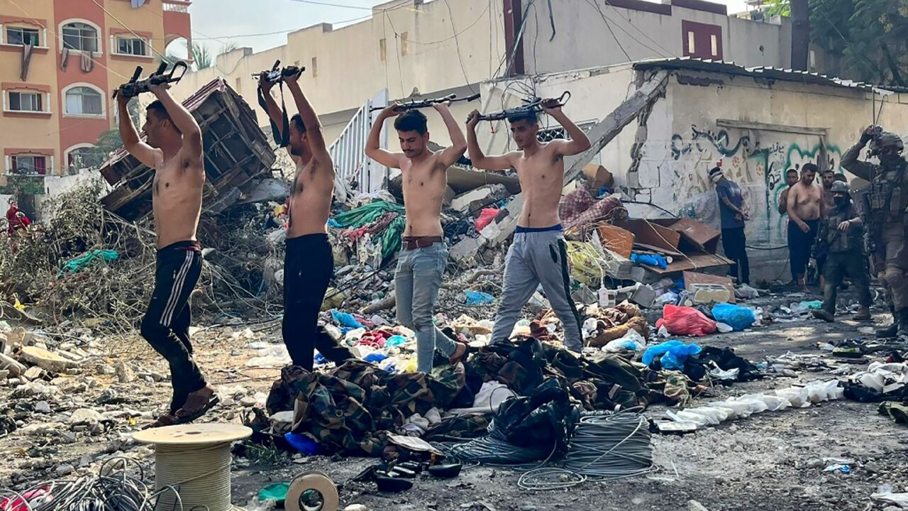 The Israeli army released this picture on December 14 showing what it said were Palestinian fighters holding weapons above their heads as they surrendered to Israeli forces near the Kamal Adwan hospital in Beit Lahia in the northern Gaza Strip