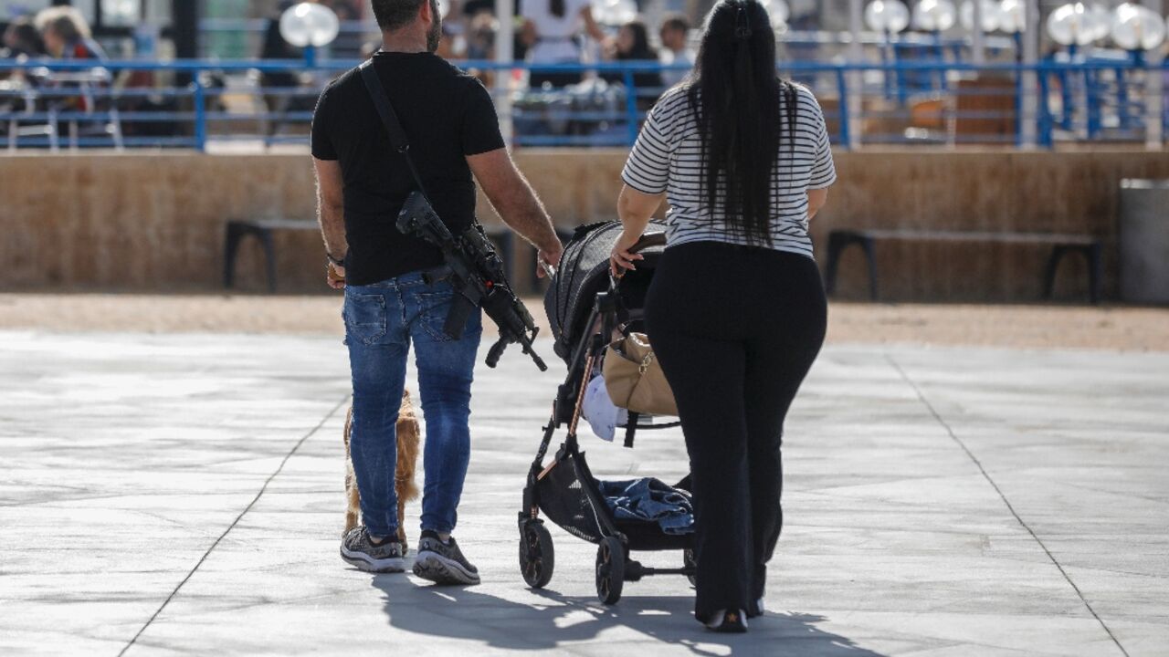 There are plenty of rifles slung over people's shoulders in Nahariya