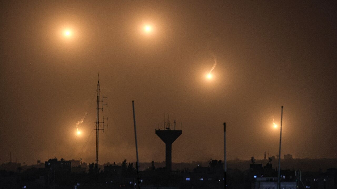 A picture taken from Rafah shows flares fired by Israeli soldiers over Khan Yunis in the southern Gaza Strip A picture taken from Rafah shows flares fired by Israeli soldiers over Khan Yunis in the southern Gaza Strip