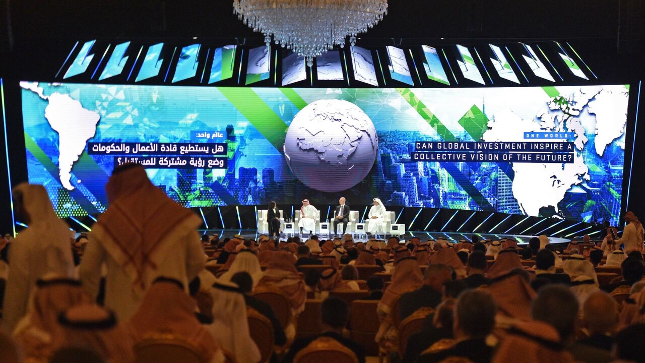 TOPSHOT - A picture taken on October 23, 2018 shows (L to R) Lubna Olayan, CEO and Deputy Chairperson Olayan Financing, Yasir al-Rumayyan, Saudi managing director of Public investment Fund, Kirill Dmitriev, CEO of Rusian Direct Investment Fund and Khaldoon Khalifa al-Mubarak, managing director and CEO of Mubadala Development Company, speaking at the opening ceremony of the Future Investment Initiative FII conference in the Saudi capital Riyadh. - Saudi Arabia is hosting a key investment summit overshadowed