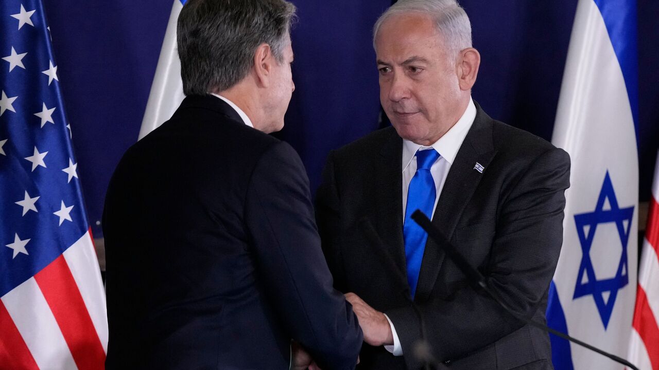 Israeli Prime Minister Benjamin Netanyahu (R) shakes hands with US Secretary of State Antony Blinken during statements to the media inside The Kirya, which houses the Israeli Defence Ministry, after their meeting in Tel Aviv on October 12, 2023. Blinken arrived in a show of solidarity after Hamas's surprise weekend onslaught in Israel, an AFP correspondent travelling with him reported. He is expected to visit Israeli Prime Minister Benjamin Netanyahu as Washington closes ranks with its ally that has launche