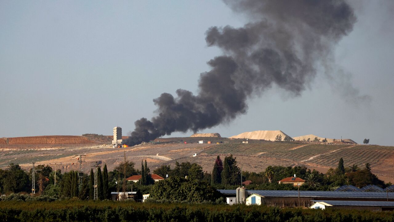 Flames and smoke rise from an agricultural structure in southern Lebanon's Khiam plain following an Israeli bombardment on Nov. 23, 2023.