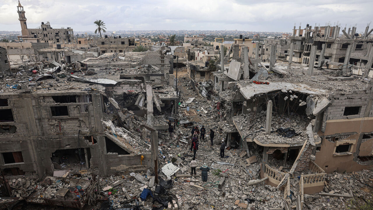 Palestinians inspect the destruction caused by Israeli strikes on their homes in the village of Khuzaa, near Abasan east of Khan Yunis near the border fence between Israel and the southern Gaza Strip on Nov. 27, 2023.