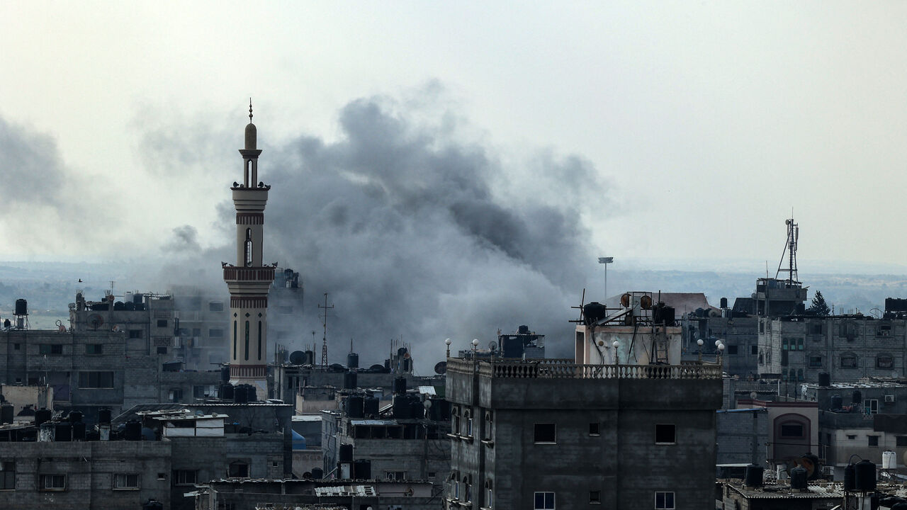 Smoke rises above buildings during an Israeli strike on Rafah near the border with Egypt, in the southern Gaza Strip on December 1, 2023, after battles resumed between Israel and the Hamas movement. A temporary truce between Israel and Hamas expired on December 1, with the Israeli army saying combat operations had resumed, accusing Hamas of violating the operational pause. (Photo by SAID KHATIB / AFP) (Photo by SAID KHATIB/AFP via Getty Images)