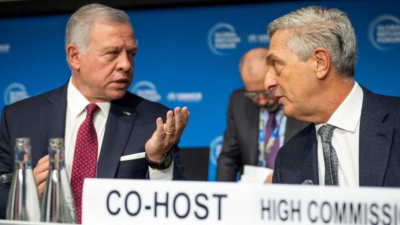 King Abdullah II of Jordan (L) speaks with UN High Commissioner for Refugees Filippo Grandi (R) during the Global Refugee Forum, in Geneva on December 13, 2023. 