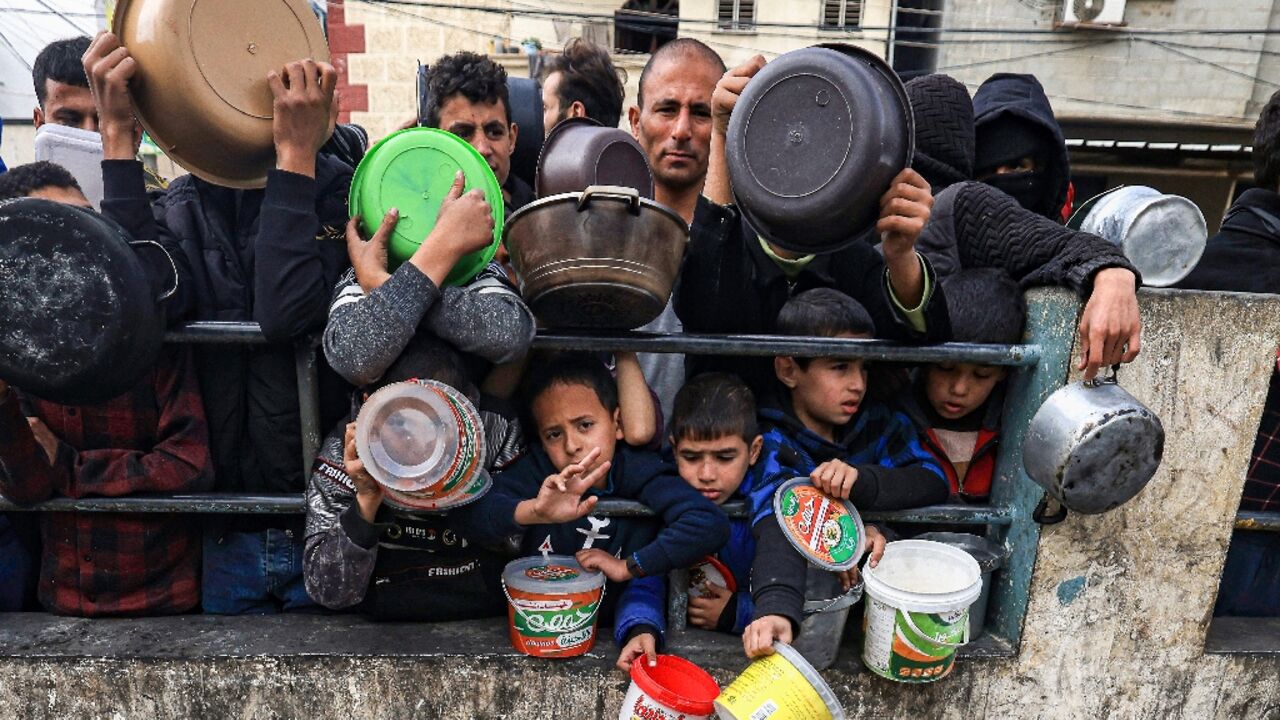 Many children are among those queueing, desparate for food Many children are among those queueing, desparate for food