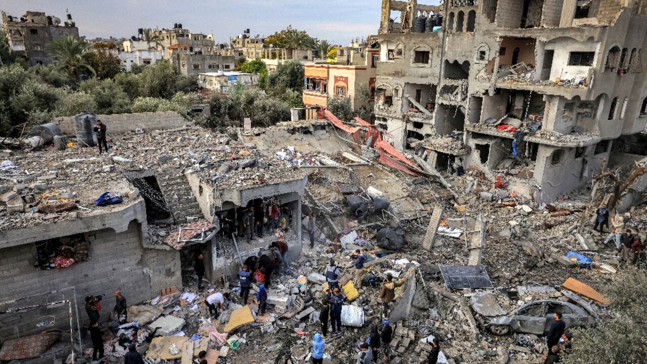 Men recover the body of a victim killed after an Israeli strike at Al-Maghazi refugee camp in central Gaza